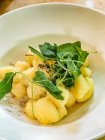 Gnocchi with sage leaves, butter and grated black pepper — Stock Photo