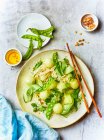 Pasta salad with melon balls, cucumber and mange tout (Asia) — Stock Photo