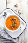 Pumpkin soup with pistachio and nutty topping — Stock Photo