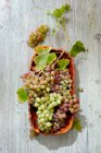 Крупным планом вкусный виноград в деревянном блюде — стоковое фото