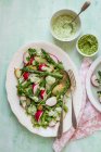 Salad from baby potatoes, asparagus and radishes with pea leaves — Stock Photo