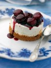 Individual gluten free cherry cheesecake on an antique plate — Stock Photo