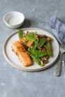Roasted salmon fillet with roasted courgette, aubergine and green peas — Stock Photo