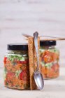 Ensalada de trigo Bulgur con jarabe de granada, cebolla, pepino, tomate, perejil y menta en frasco de vidrio - foto de stock