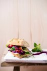 Baguete com salada (alface iceberg, repolho vermelho, alface de cordeiro, tomate, agrião) — Fotografia de Stock