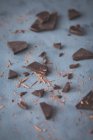 Chocolate pieces on a dark surface — Photo de stock