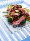 Griddled sirloin steak strips and vegetable salad — Stock Photo
