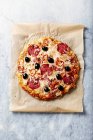 Rustic pizza with spicy salami, cheese and red chili peppers — Stock Photo