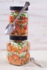 Bulgur wheat salad with pomegranate syrup, onions, cucumber, tomatoes, parsley and mint in glass jars — Stock Photo