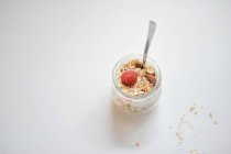 Honey and almond muesli with raspberries in a glass — Stock Photo