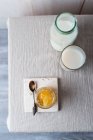 A glass of honey milk, a milk bottle and honey in a jar — Stock Photo