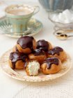 Profiteroles in a table setting — Stock Photo