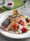 Roasted Salmon with cherry tomatoes and coconut rice — Stock Photo