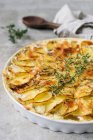 Potatoes au gratin with thyme — Stock Photo