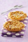 Pine nut tartlets on dotted cloth — Stock Photo