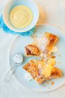 Apple and quark turnovers with icing sugar and custard — Stock Photo