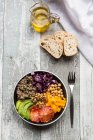 A veggie bowl with quinoa, chickpeas, avocado, peppers, red cabbage and blood oranges — Stock Photo