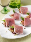 Roast figs and prosciutto canapes — Stock Photo
