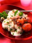 Prawns in creamy sauce with vine tomatoes and herbs — Stock Photo