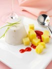 Lime and coconut panna cotta with raspberry coulis and mango pieces lactose and gluten freee — Stock Photo