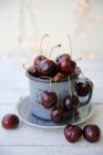 Cherries in an enamel mug close-up view — Stock Photo