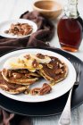 Pancakes with bananas, maple syrup and pecans — Stock Photo