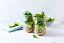Layered buckwheat salad with leek, pepper and spinach in a jar — Stock Photo