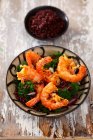 Deep-fried prawns on broccoli and red rice — Stock Photo