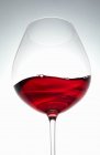 Una ola de vino tinto en una copa - foto de stock