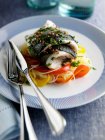 Rolled sea bass on bed of bell peppers — Stock Photo