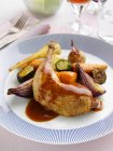 A roast leg and thigh of guinea fowl and vegetables — Stock Photo