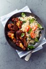 Spicy chicken pieces and basmati rice with spinach — Stock Photo