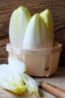 Organic chicory in a wooden basket — Stock Photo