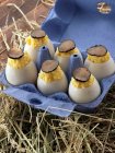 Truffled scrambled duck eggs in a carton — Stock Photo