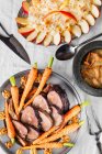 Beef roast with carrots and sauerkraut with apple — Stock Photo