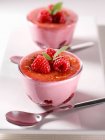 Raspberry creme brulee in two glasses decorated with raspberries — Stock Photo