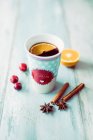 Cherry mulled wine in a porcelain mug — Stock Photo