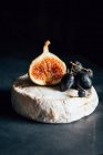 Camembert cheese with grapes and fig — Stock Photo