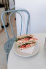 Sandwich with mozzarella, tomatoes and arugula — Stock Photo