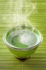 A steaming bowl of matcha tea — Stock Photo
