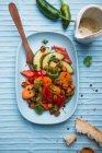Warm salad made from roasted carrots, peppers, chilli peppers, cucumber and roasted chickpeas — Stock Photo