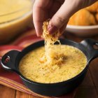 Broccoli and cheese soup topped with cheddar — Stock Photo