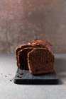 Chocolate box cake with cocoa nibs, cut — Stock Photo