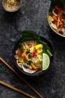 Noodle soup with carrots, mushrooms, pak choi and sesame seeds — Stock Photo