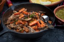 Carrot and mushroom fry in cast iron pan — Stock Photo
