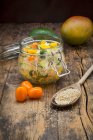 Quinoa salad with avocado, cucumber, tomato and mango in a glass jar — Stock Photo