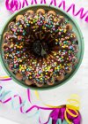 Gugelhupf with chocolate glaze and sugar confetti for carnival — Stock Photo