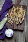 Fried breaded asparagus with almond flour and sesame seeds, and a herb dip — Stock Photo