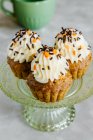 Gewürzte Karotten-Nüsse-Cupcakes, dekoriert mit Frischkäse-Zuckerguss und Streusel — Stockfoto