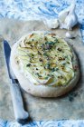 Pizza with fresh cheese, garlic, sliced potatoes, and thyme — Stock Photo